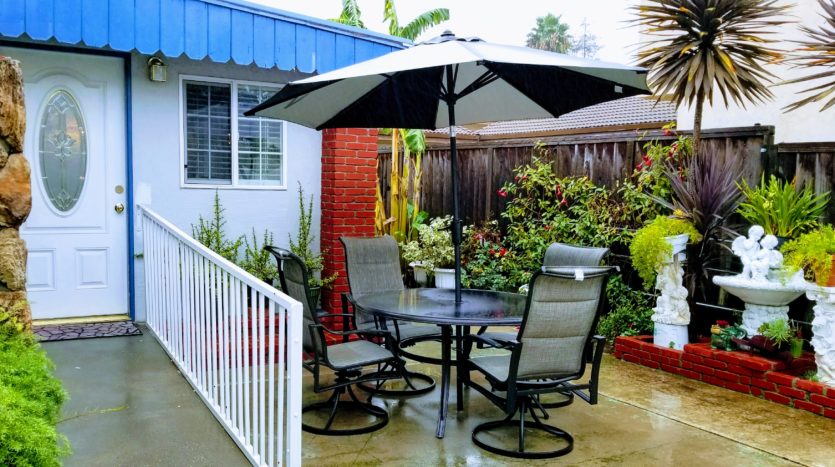 A patio table with chairs and an umbrella.