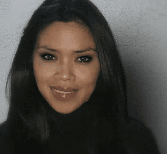 A woman with long black hair and green eyes.