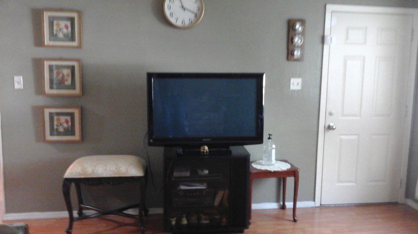 A flat screen tv sitting on top of a black stand.