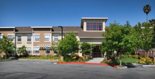 A large building with flowers in front of it.