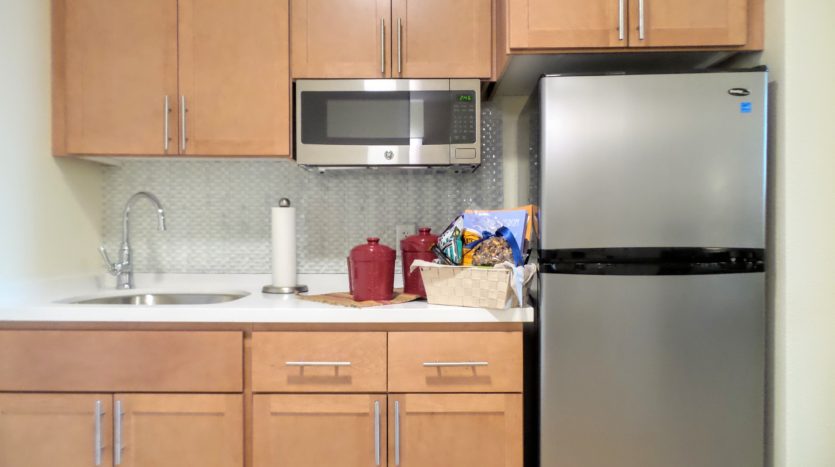 A kitchen with wooden cabinets and stainless steel appliances.