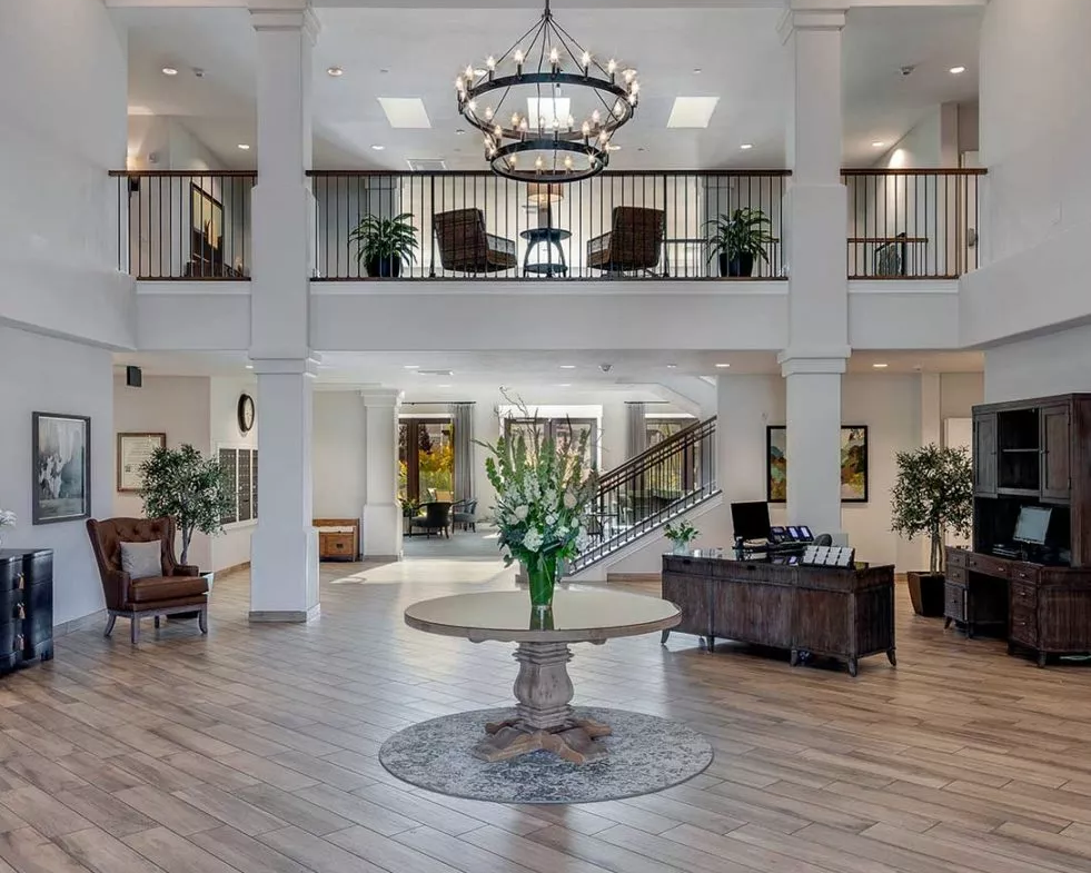 A large lobby with a plant in the center of it.