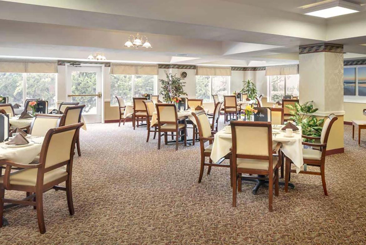 A large room with many chairs and tables.