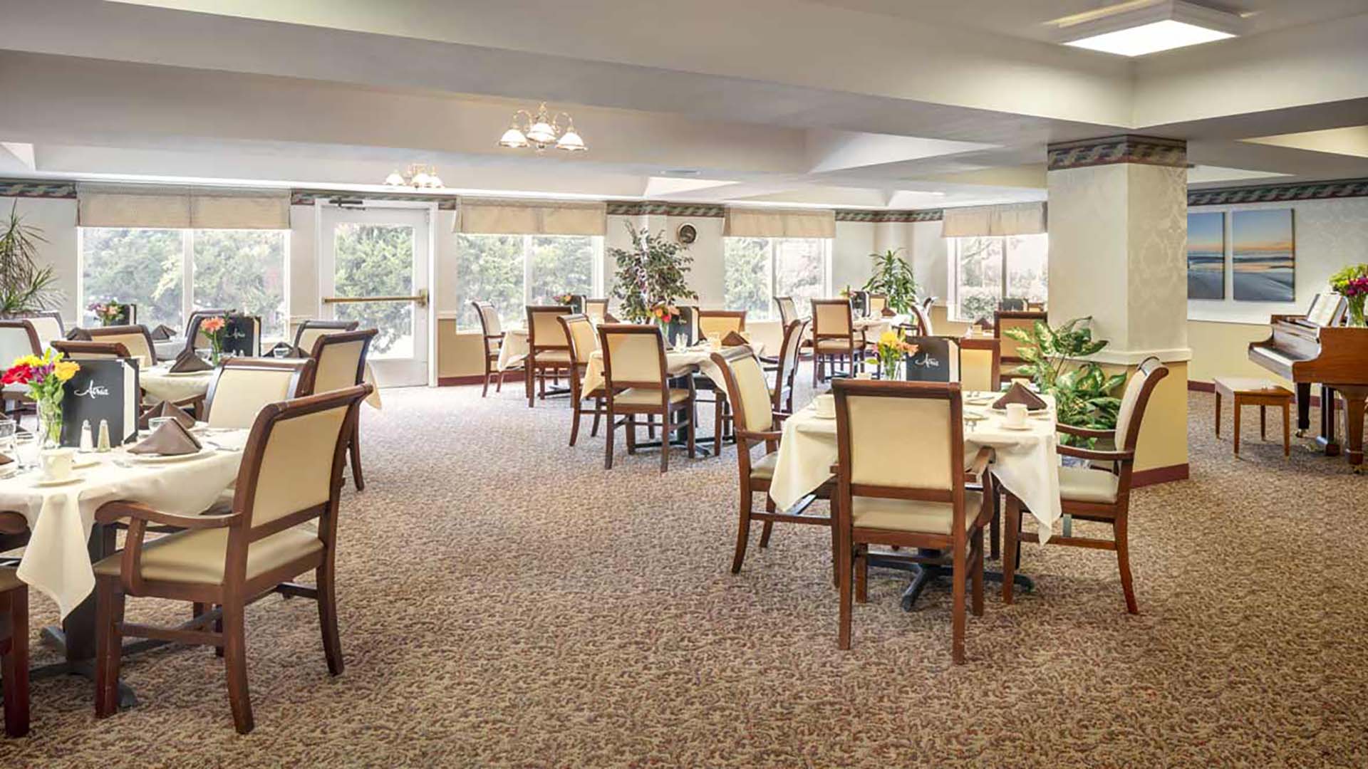 A large room with many chairs and tables.