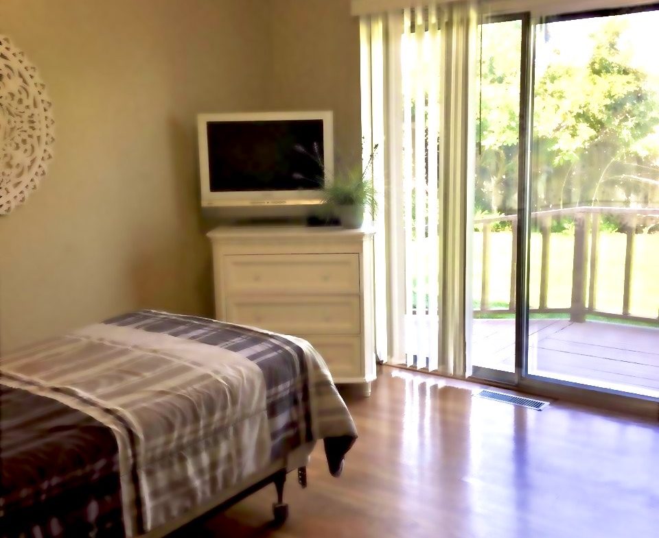 A bedroom with a bed and television in it