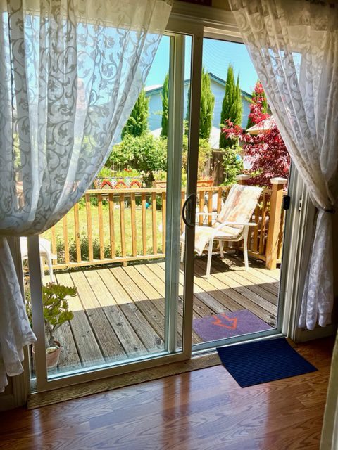 A sliding glass door with curtains open on the outside.