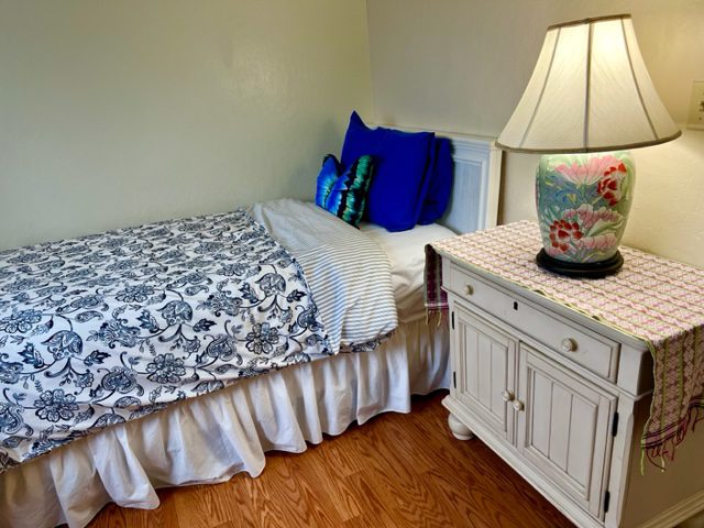 A bedroom with a bed and nightstand in it