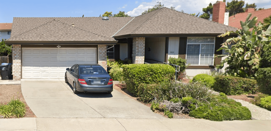 A car parked in front of a house.