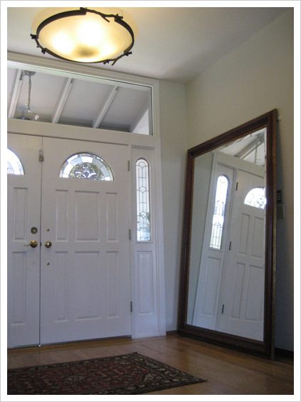 A large mirror in the corner of a room