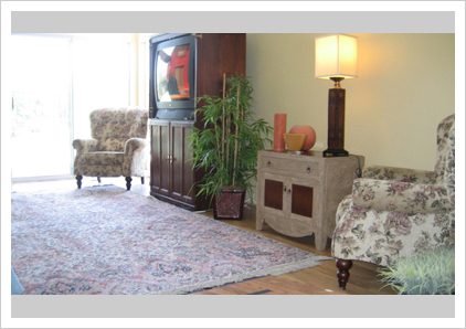 A living room with a television and chair