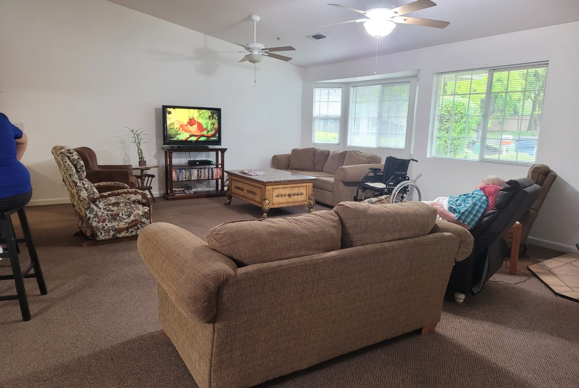 A living room with couches and chairs, television.