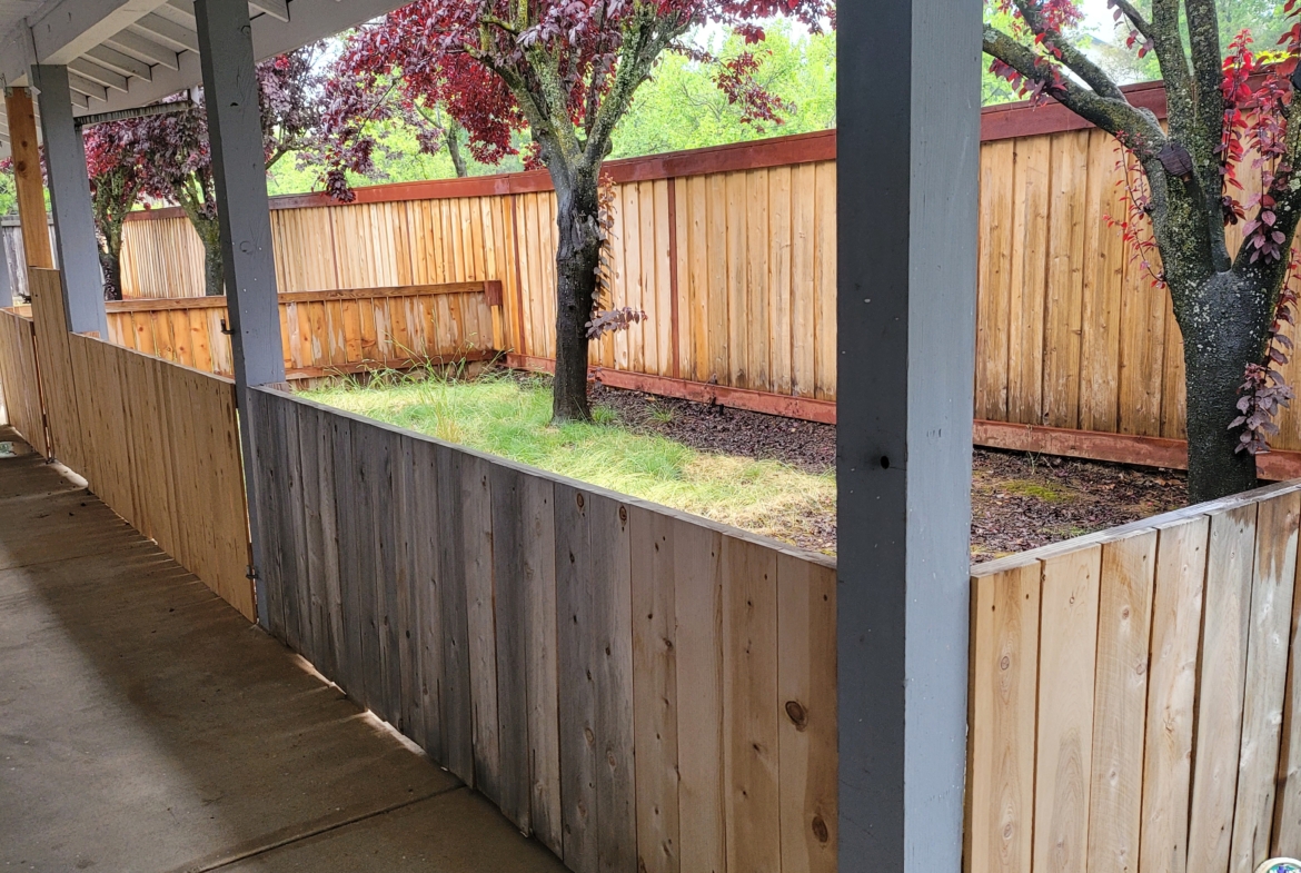 A wooden fence with trees in the background