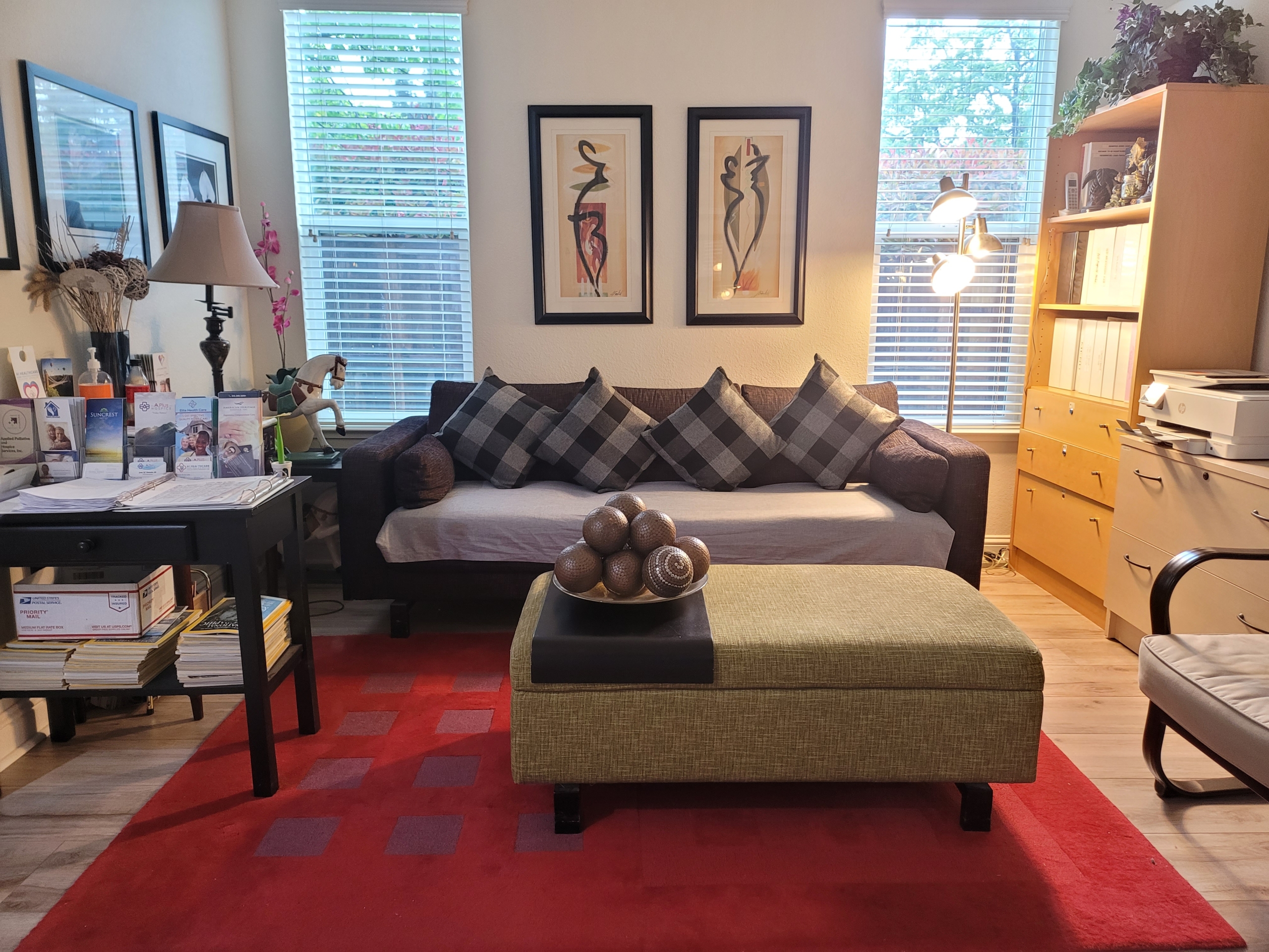 A living room with two large paintings on the wall.