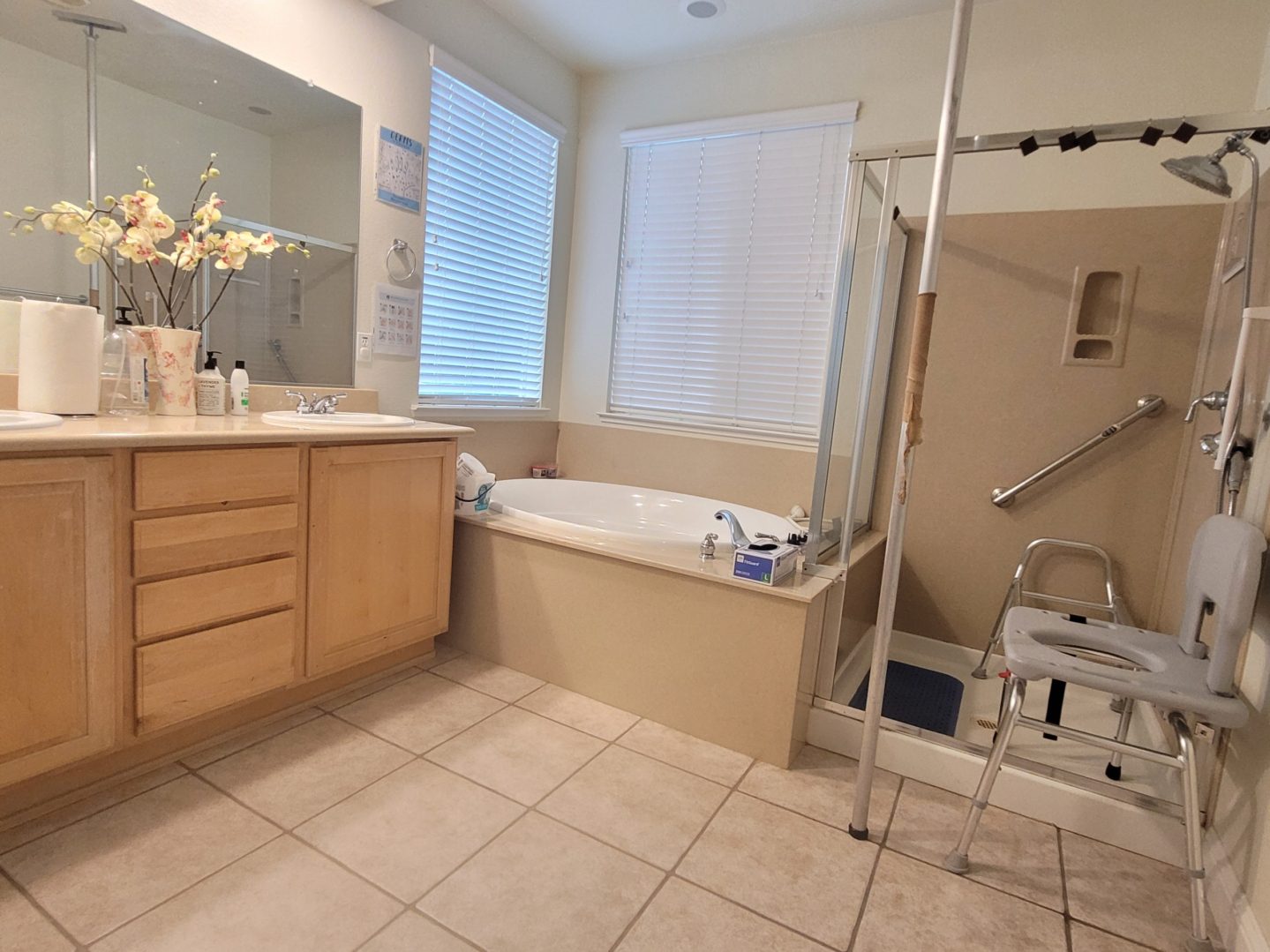 A bathroom with a tub, shower and sink.