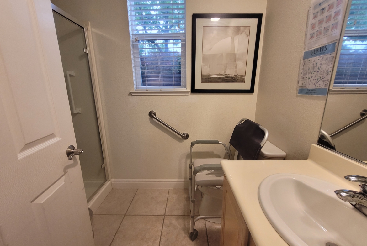 A bathroom with a sink, toilet and shower.