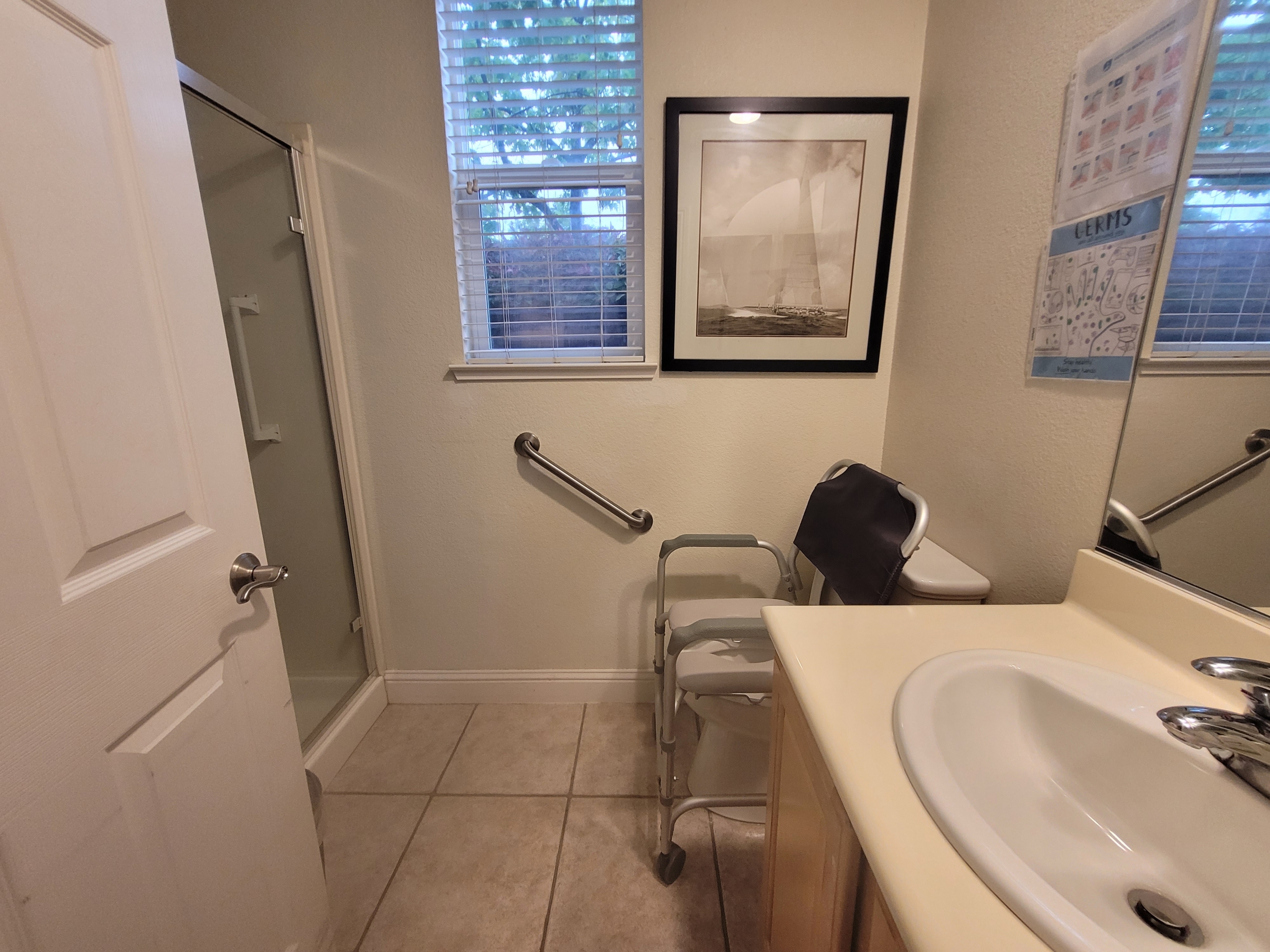 A bathroom with a sink, toilet and shower.