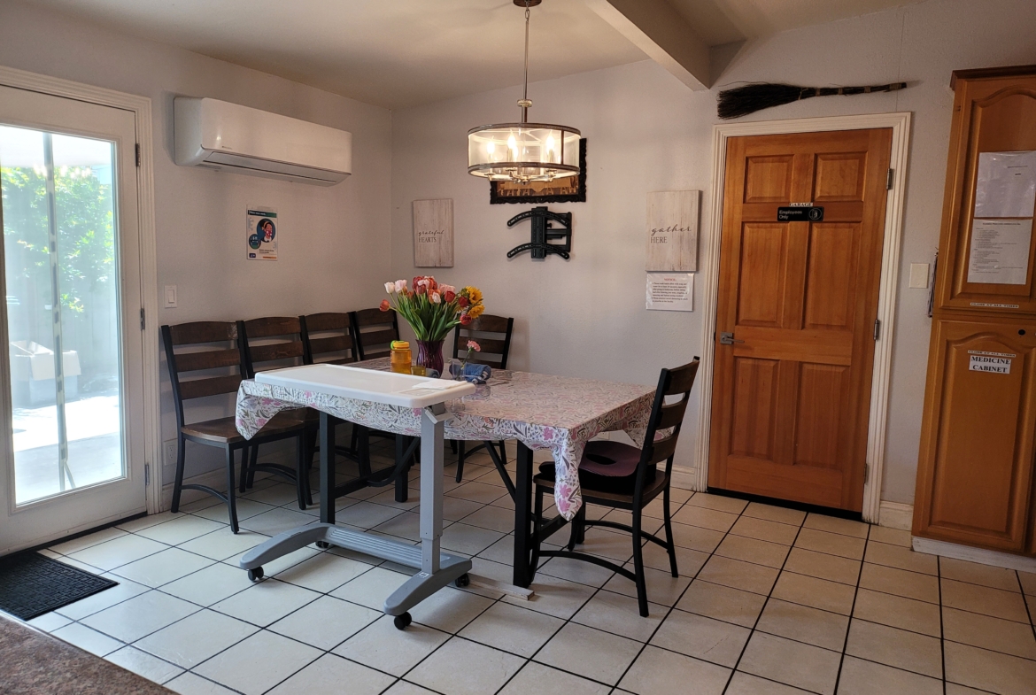 A dining room table with chairs and a door.