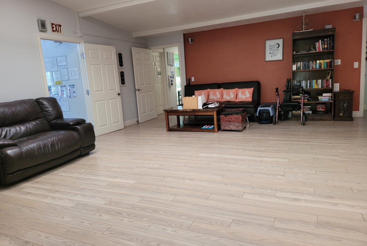 A living room with hard wood floors and furniture.