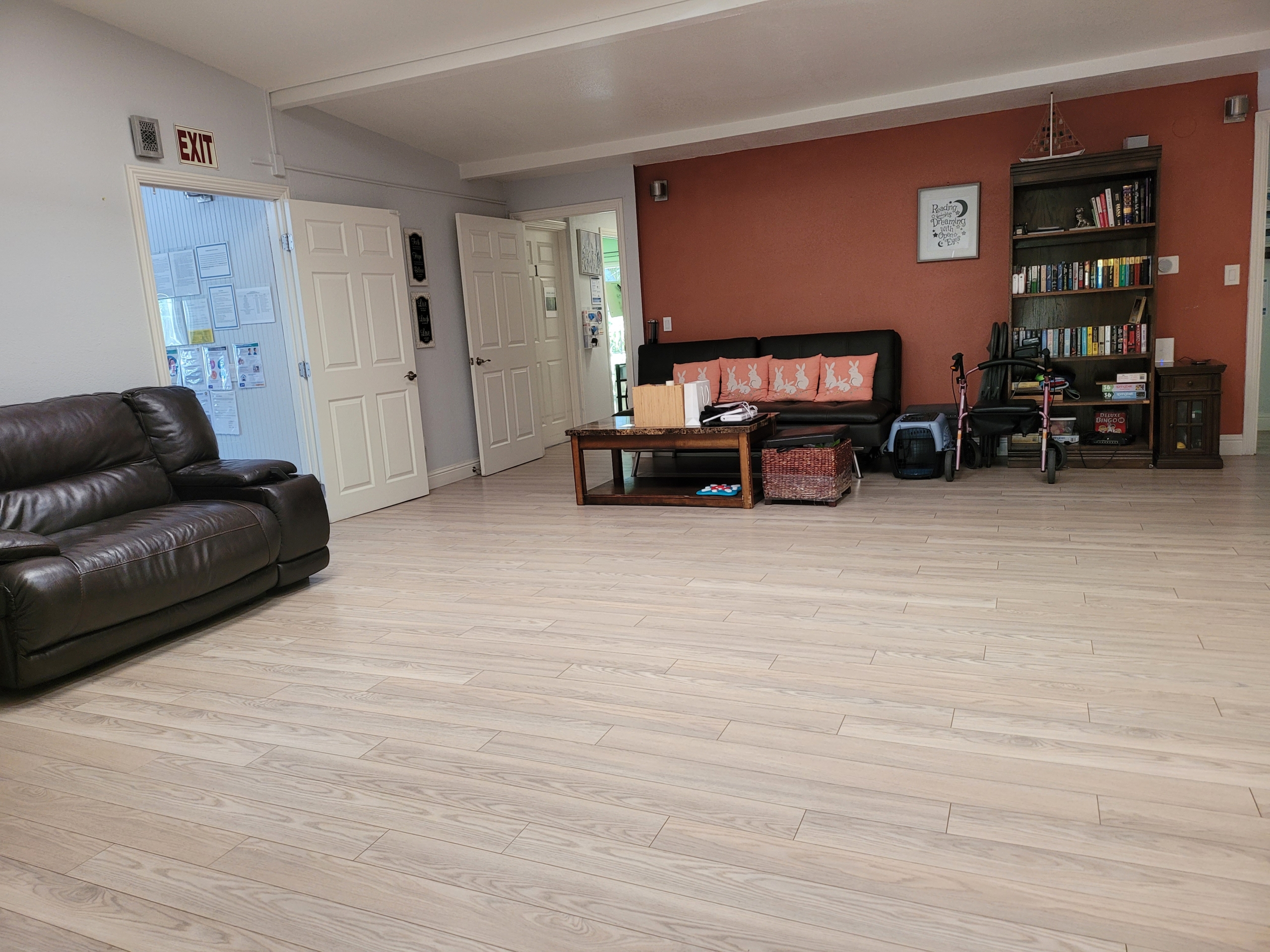 A living room with hard wood floors and furniture.