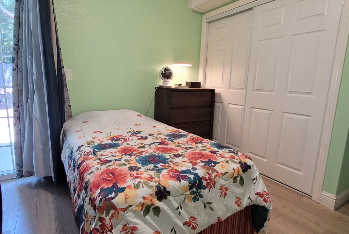 A bedroom with a bed and closet in it