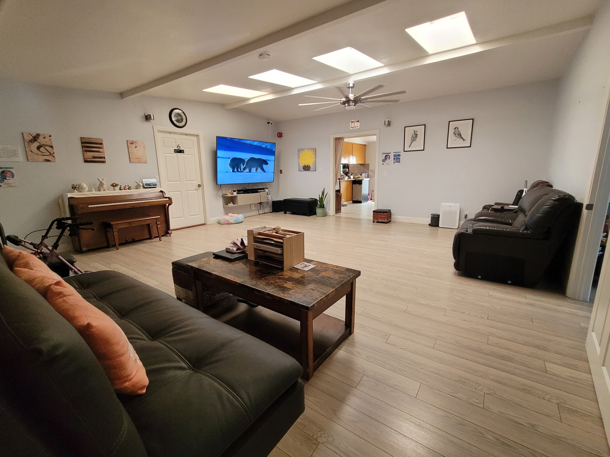 A living room with a couch, table and television.