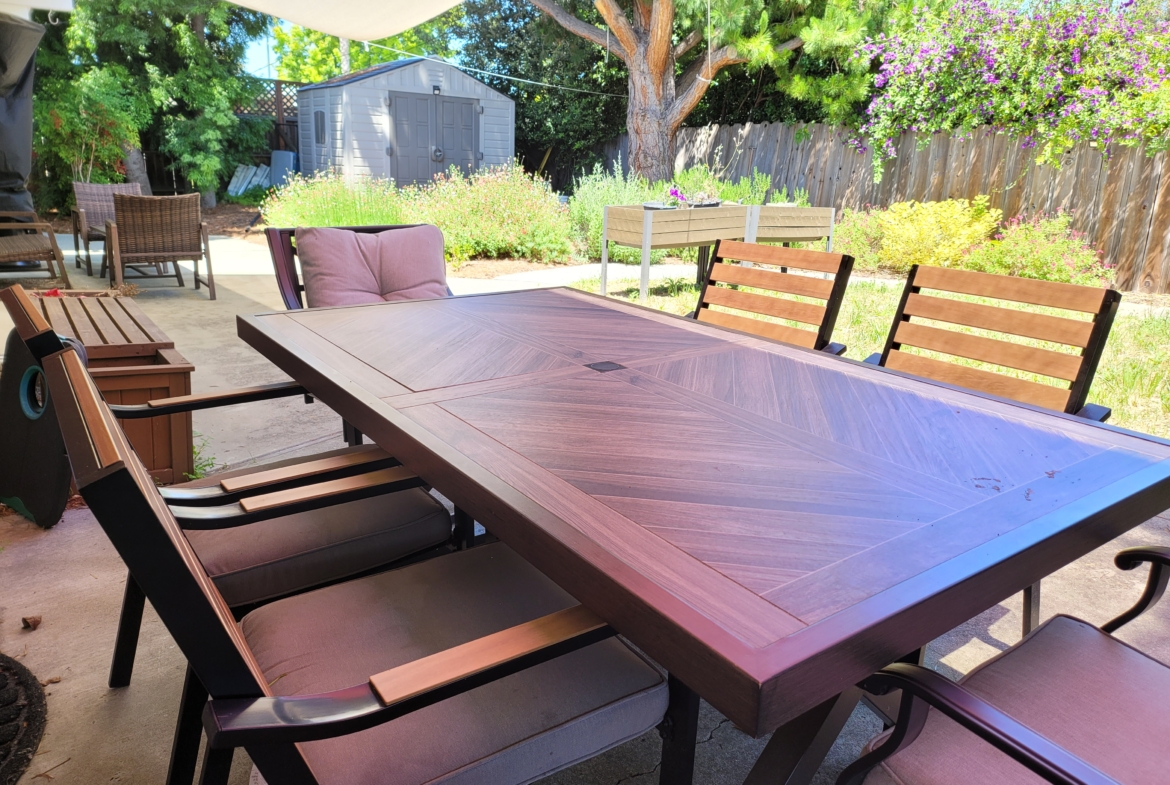 A table and chairs set up outside in the sun.