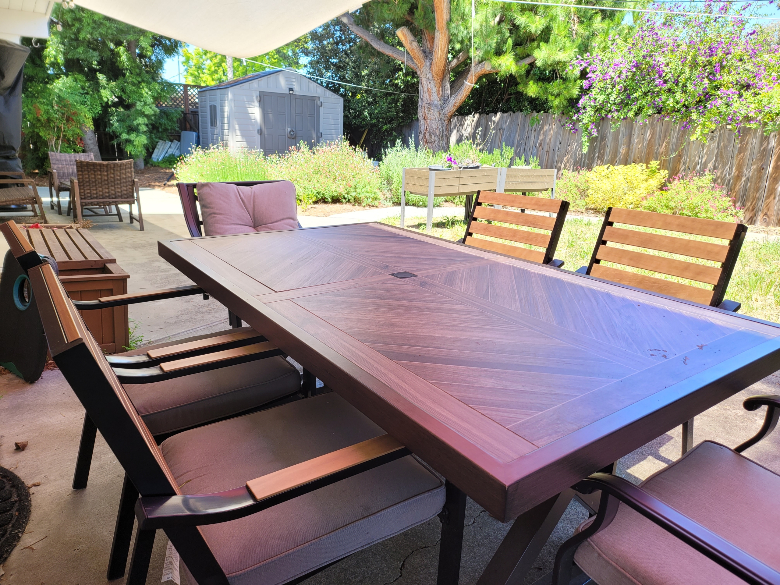 A table and chairs set up outside in the sun.