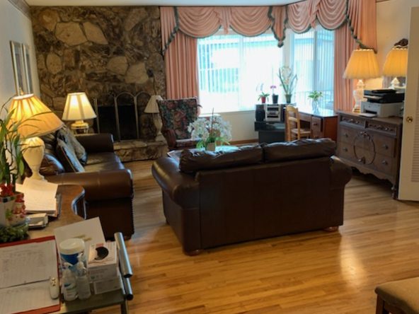 A living room with hard wood floors and furniture.