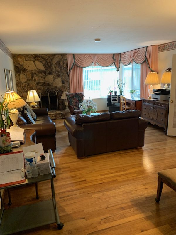 A living room with hard wood floors and furniture.