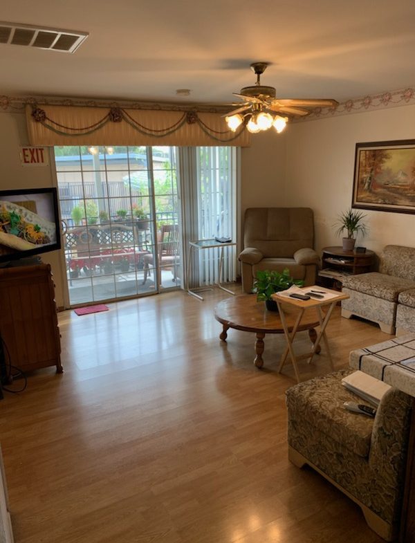 A living room with wooden floors and furniture.