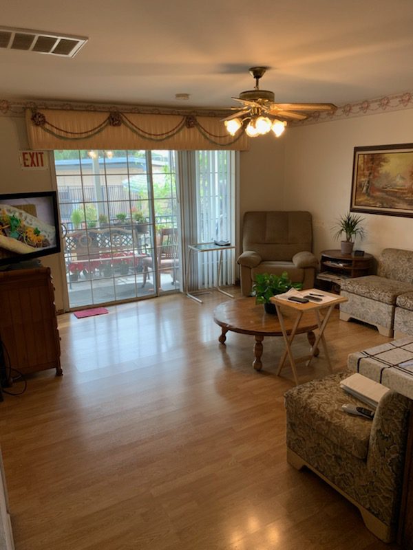 A living room with wooden floors and furniture.