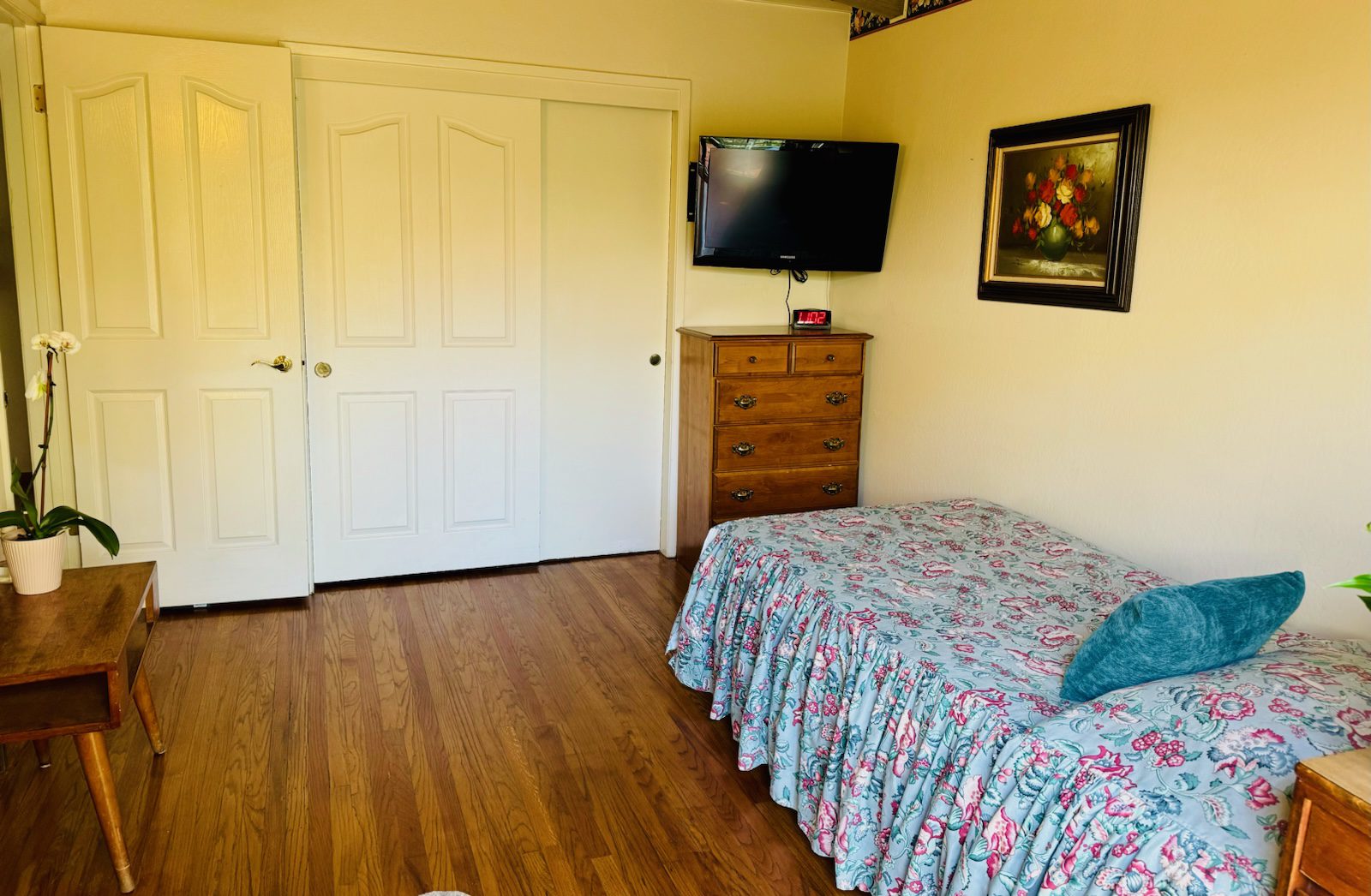 A bedroom with a bed and television in it