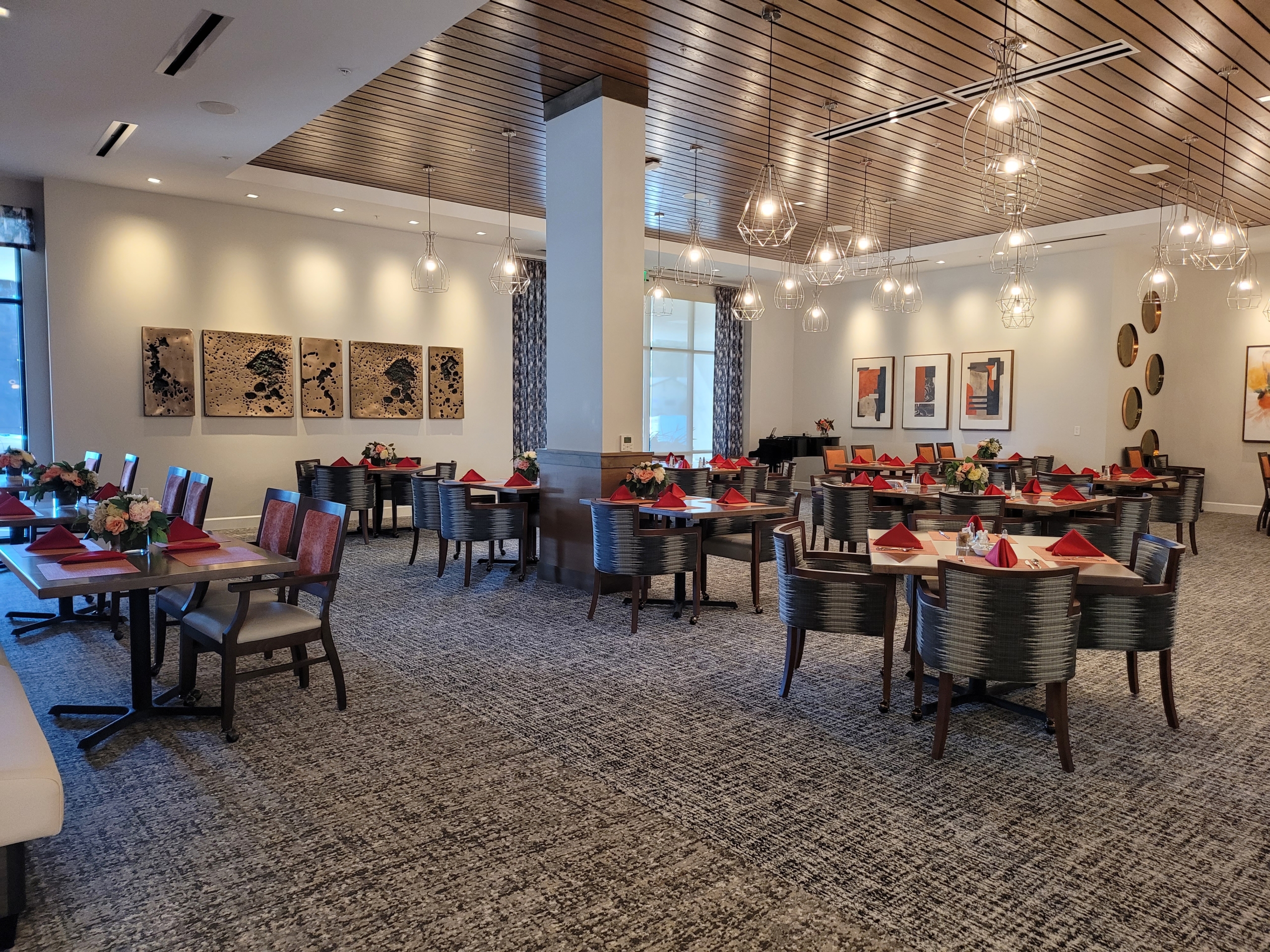 A restaurant with many tables and chairs in it