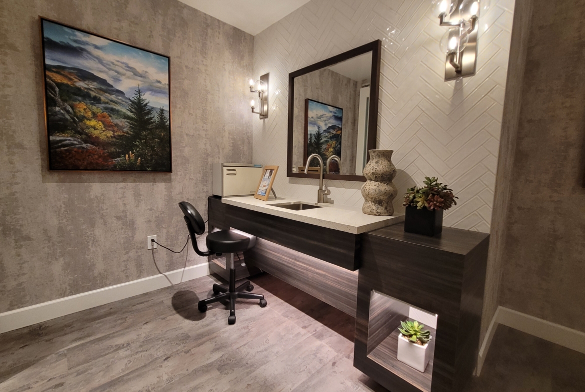 A bathroom with a sink and mirror in it