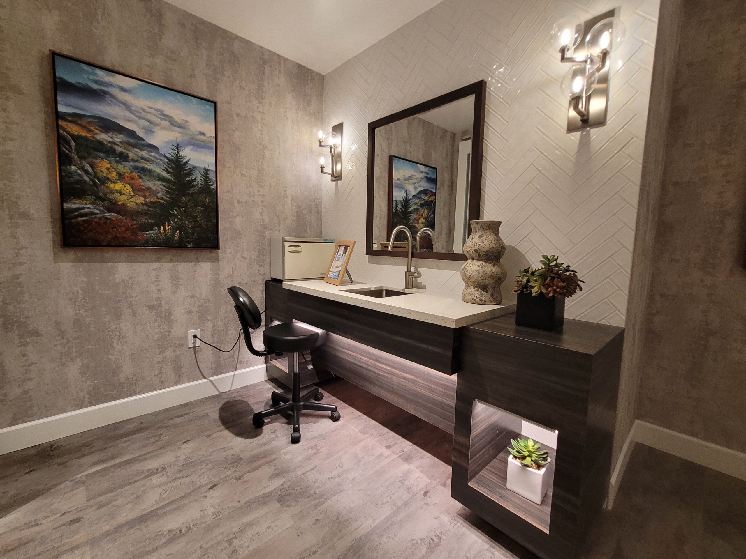 A bathroom with a sink and mirror in it