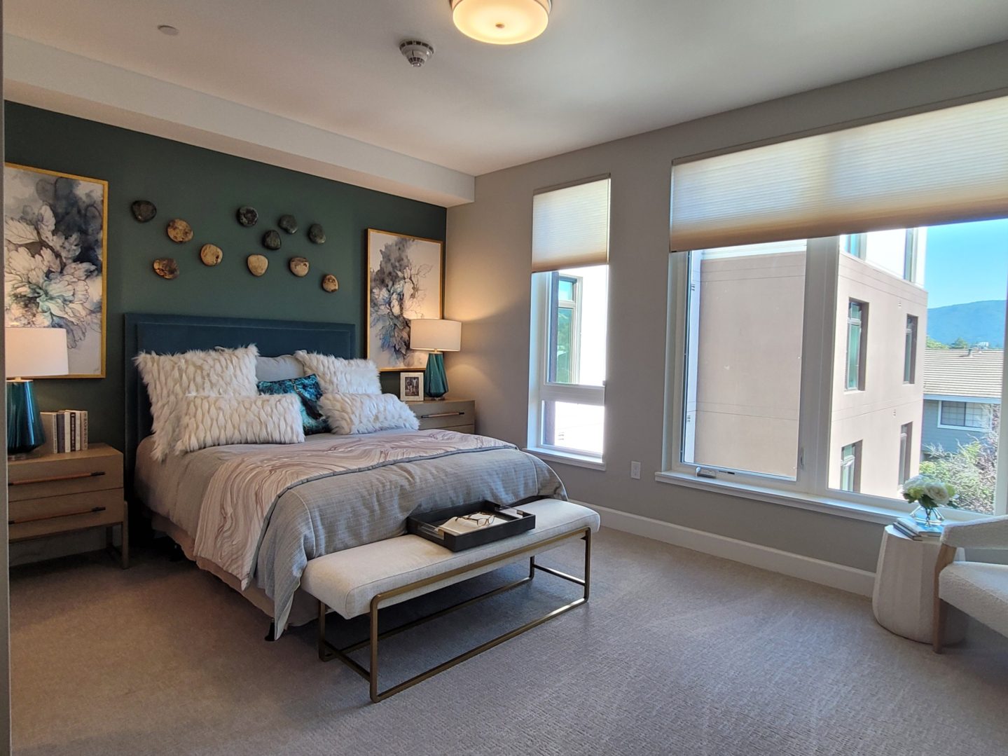 A bedroom with a bed, window and bench.