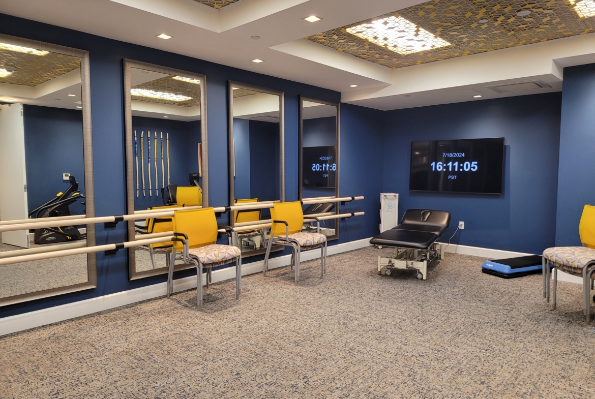 A room with blue walls and yellow chairs.