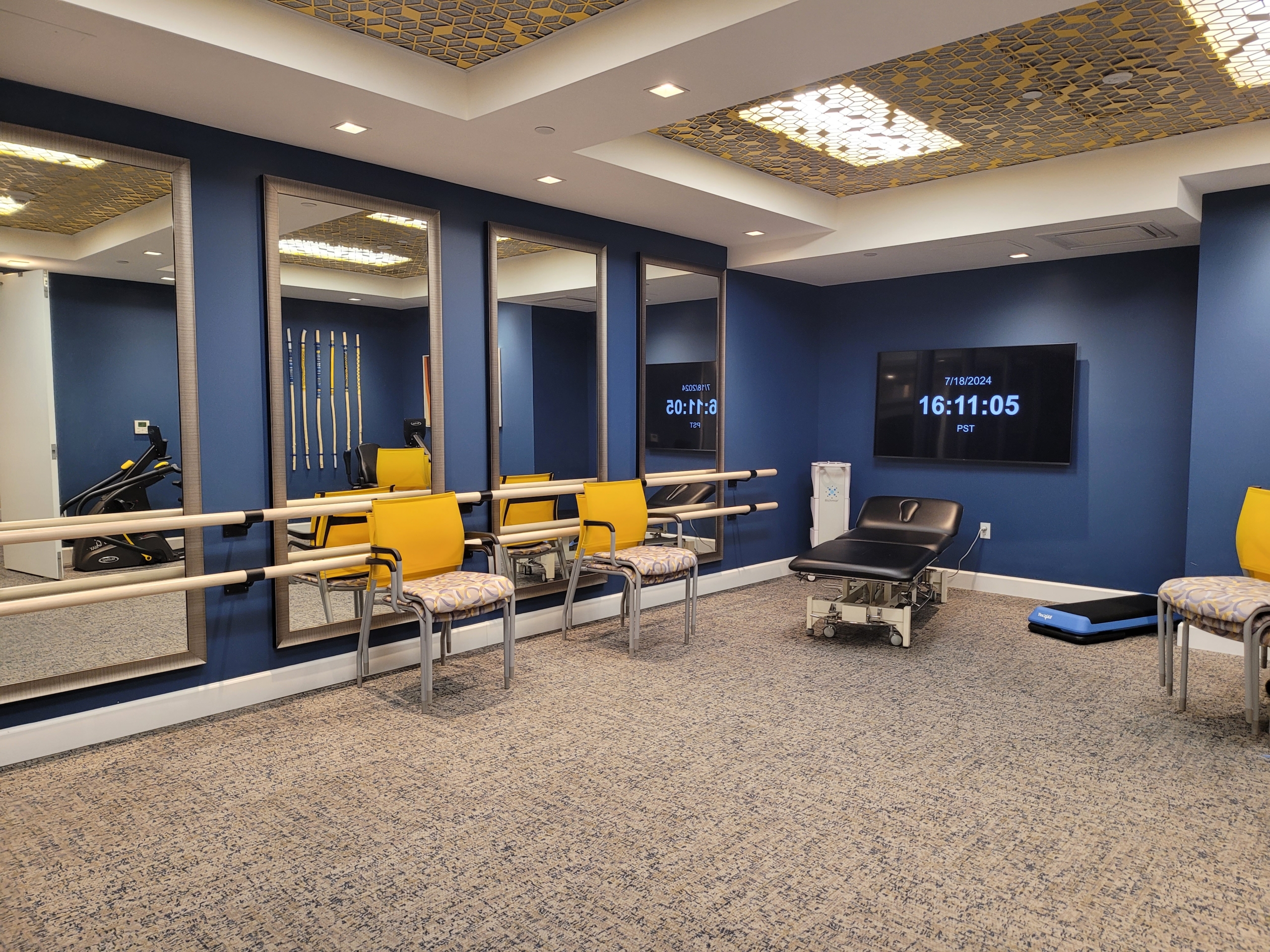 A room with blue walls and yellow chairs.