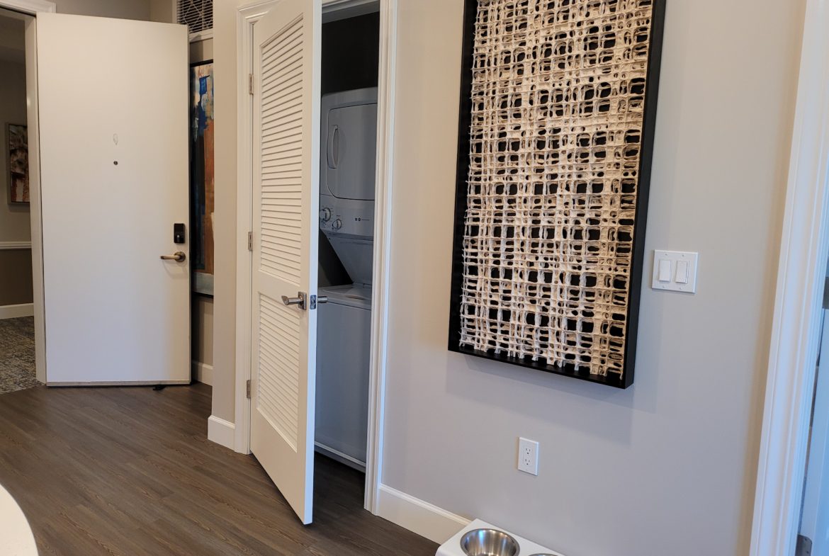 A dog bowl sitting in front of an open door.