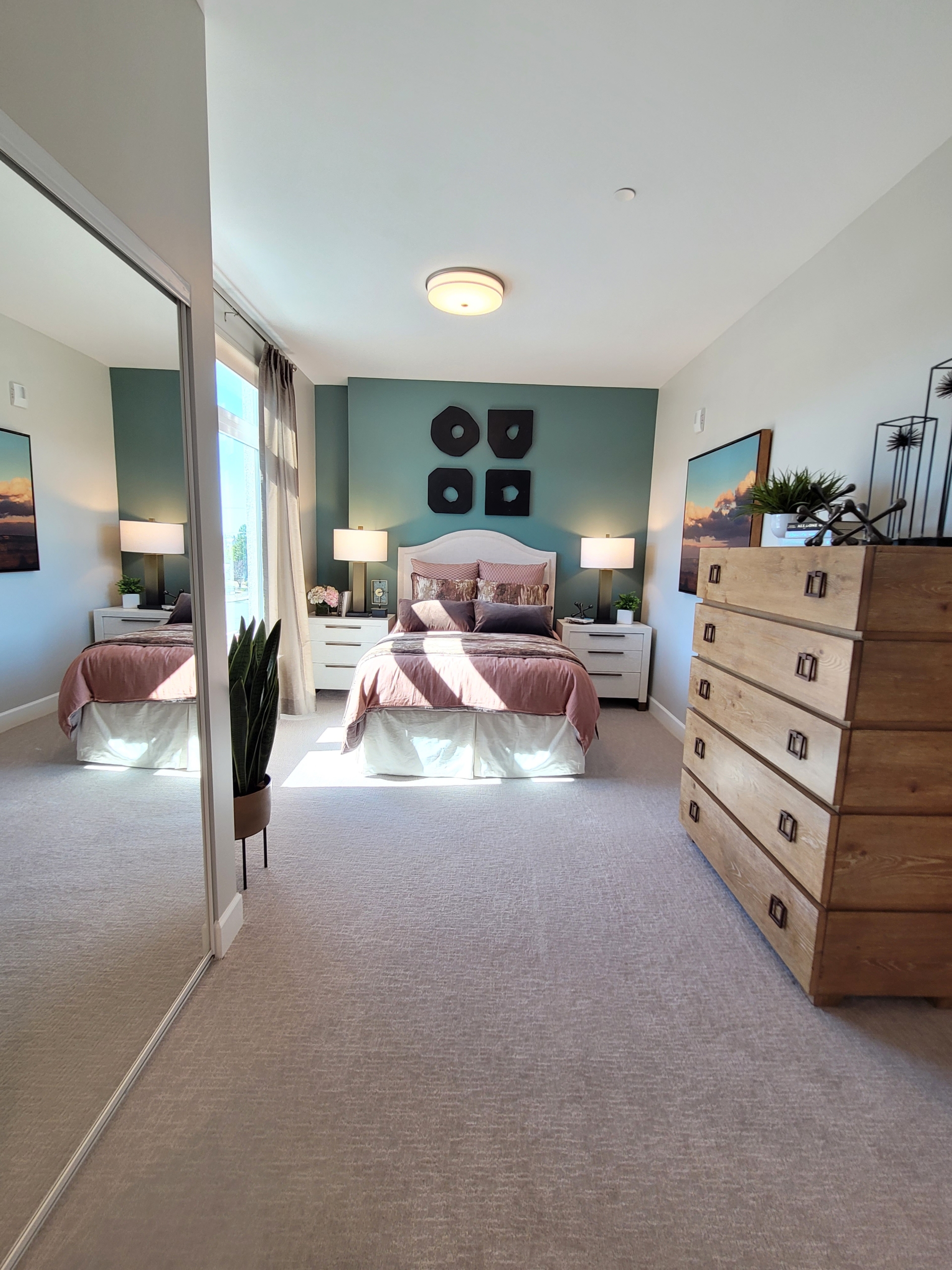 A bedroom with two beds and a dresser in it