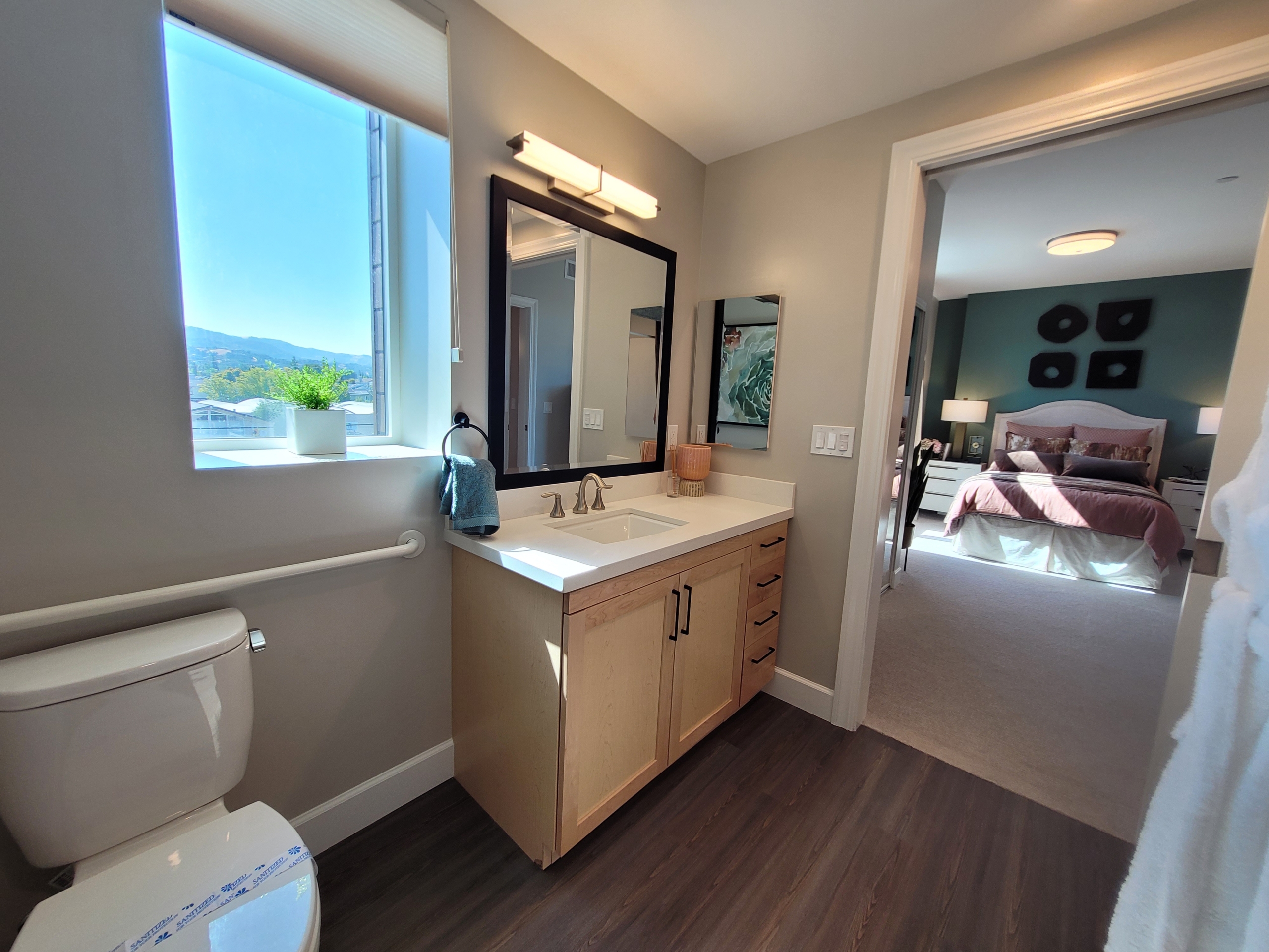 A bathroom with a sink, mirror and toilet.