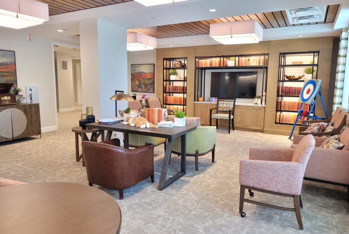 A living room with couches, tables and chairs.