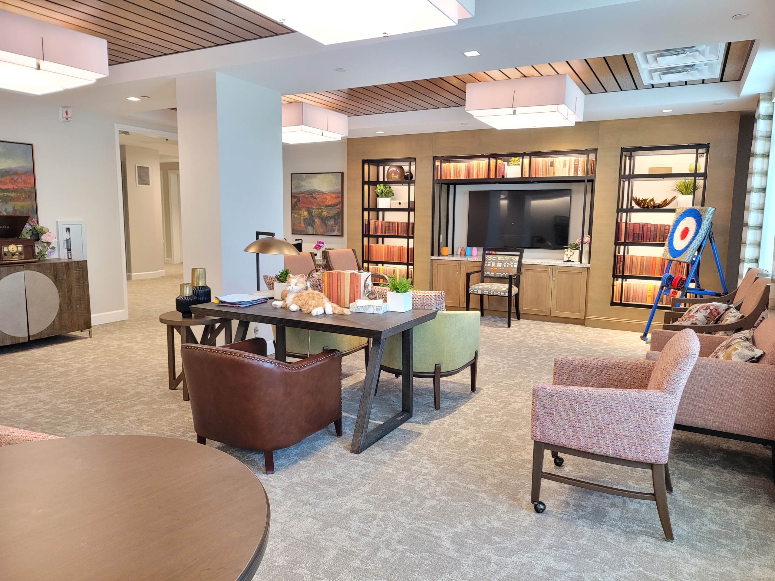 A living room with couches, tables and chairs.