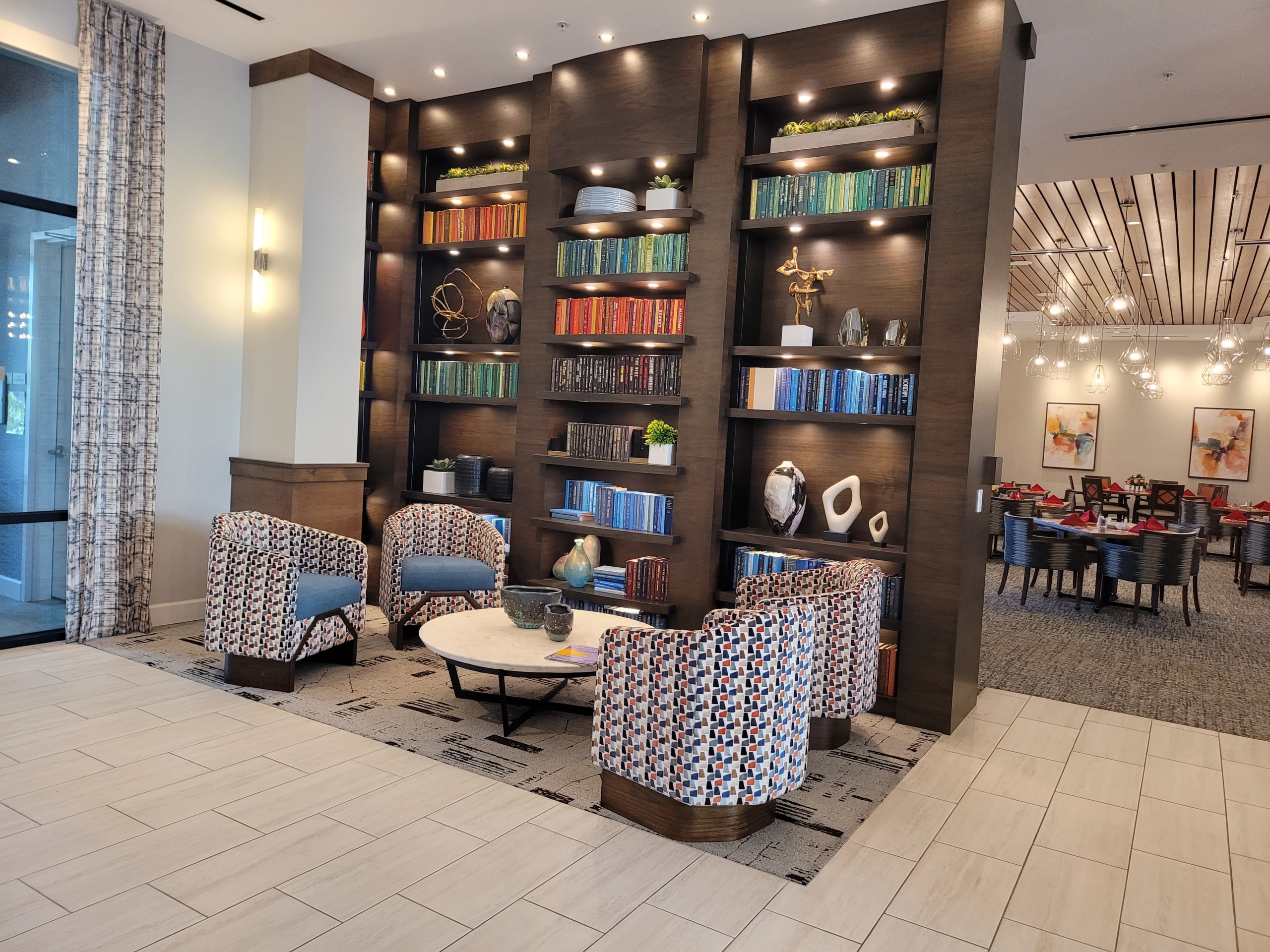 A room with several chairs and shelves of books.