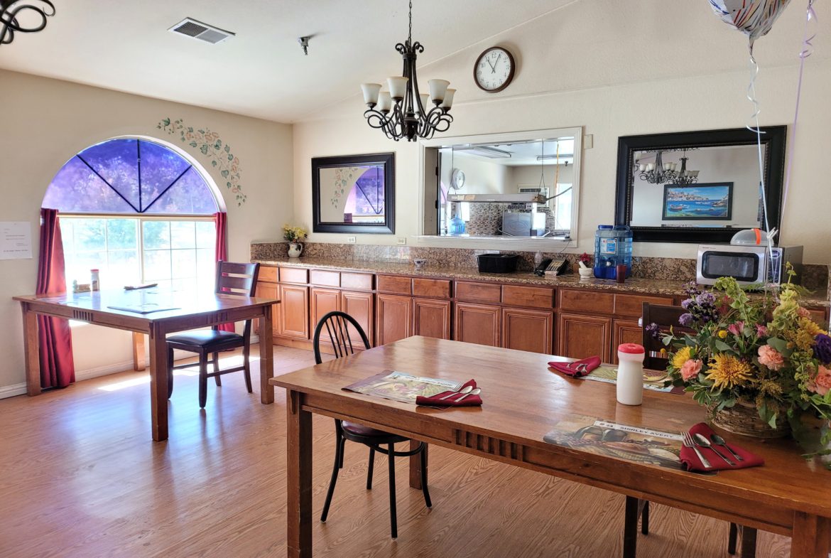 A dining room with wooden tables and chairs.