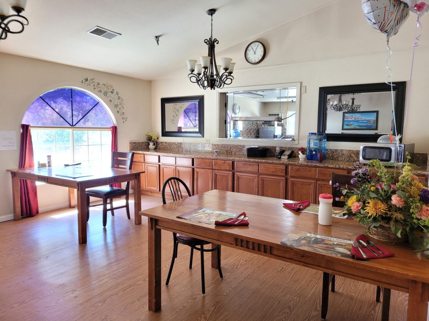 A dining room with wooden tables and chairs.