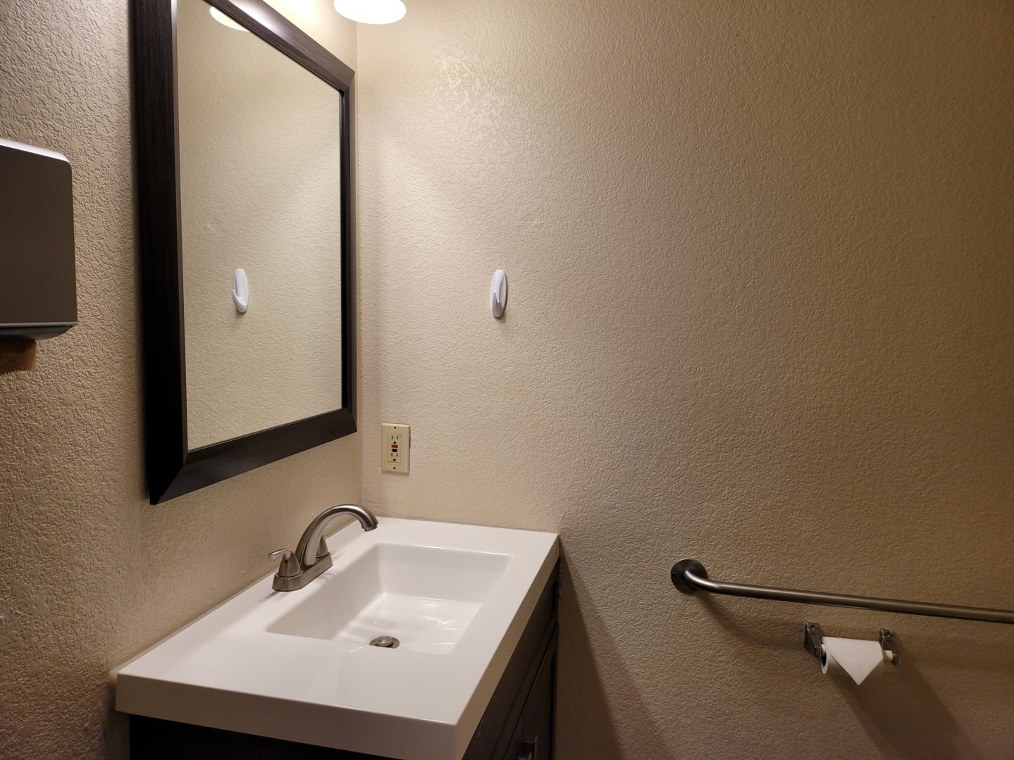 A bathroom with a sink and mirror in it