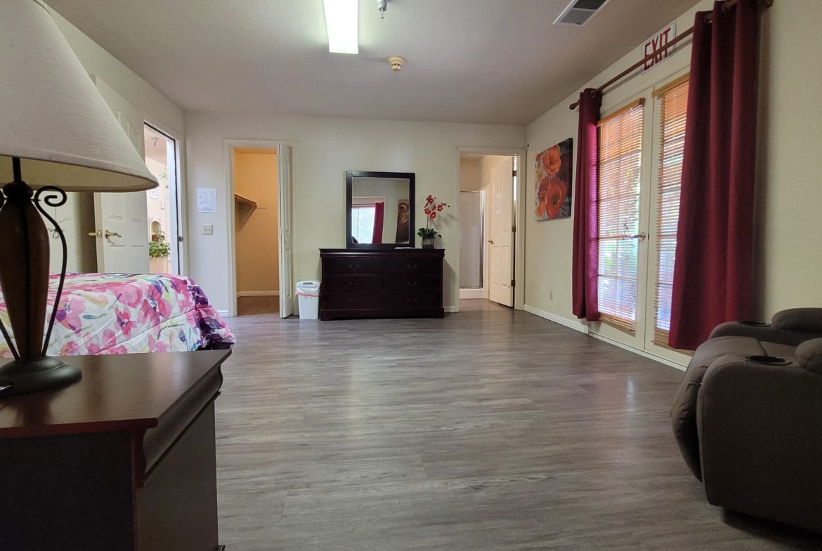 A room with a desk and a couch in it