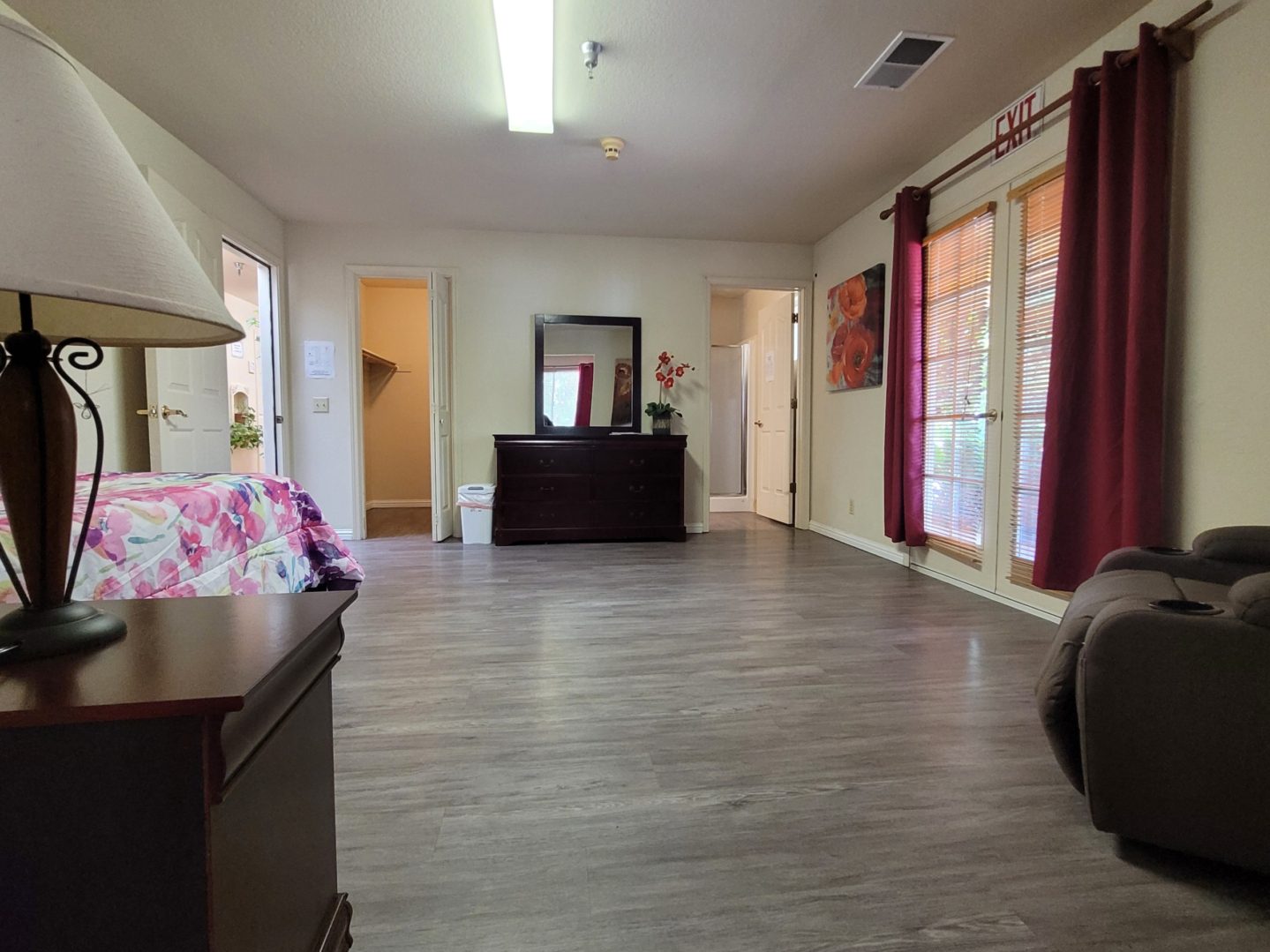 A room with a desk and a couch in it