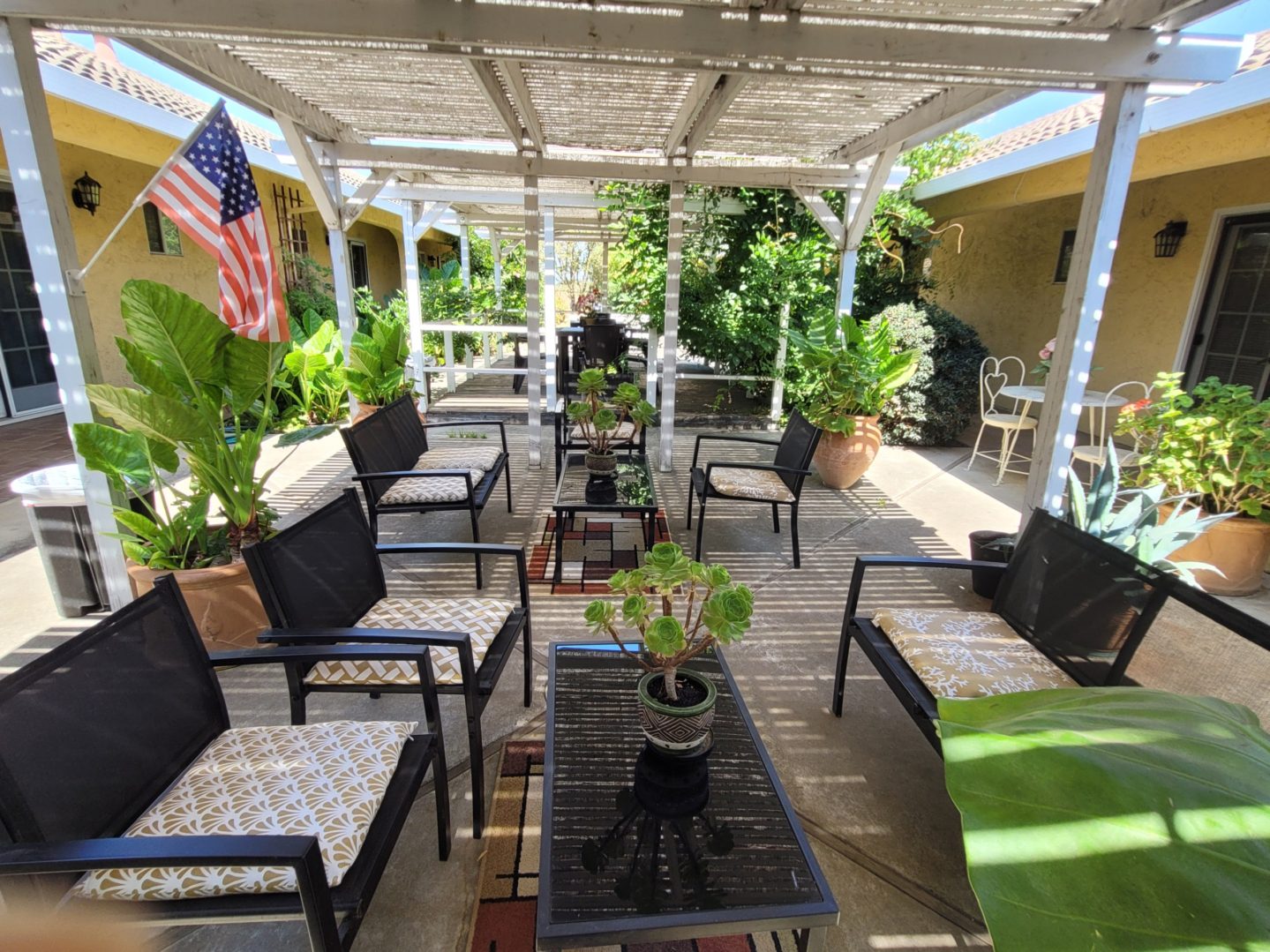 A patio with many chairs and tables in it